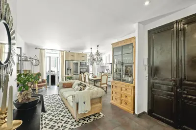 a living room with a couch and a dining room at Immogroom - T4 - Center - 8 min from Palais in Cannes