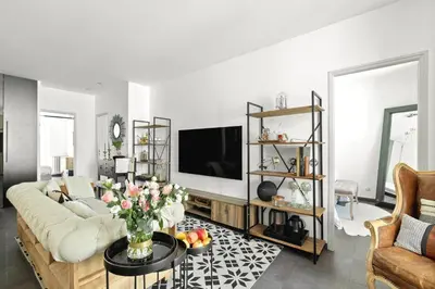 a living room with a couch and a tv at Immogroom - T4 - Center - 8 min from Palais in Cannes
