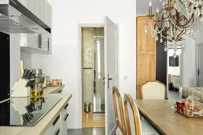 a kitchen and dining room with a chandelier at Immogroom - T4 - Center - 8 min from Palais in Cannes