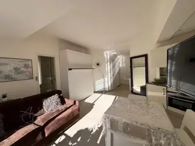 a living room with a couch and a table at Elegant studio a 50m de la Croisette et ses plages - Ada Serenity Beach in Cannes