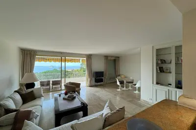 a living room with a couch and a table at Appartment with exceptional view on the sea in Cannes