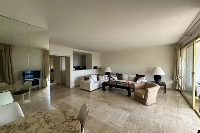 a living room with a couch and a table at Appartment with exceptional view on the sea in Cannes