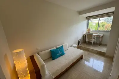 a living room with a couch and a table at Appartment with exceptional view on the sea in Cannes