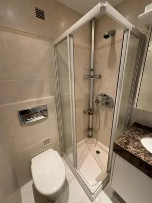 a bathroom with a shower and a toilet and a sink at Appartment with exceptional view on the sea in Cannes