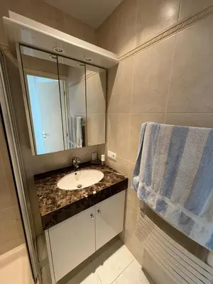 a bathroom with a sink and a mirror at Appartment with exceptional view on the sea in Cannes