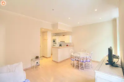 a living room with a table and a kitchen at ALC - FONT3 - 10 min PALAIS in Cannes