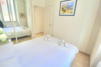 a white room with two beds and a mirror at ALC - FONT3 - 10 min PALAIS in Cannes