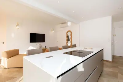 a kitchen with a white counter and a living room at Carlton area lux 2 beds 2 baths in Cannes