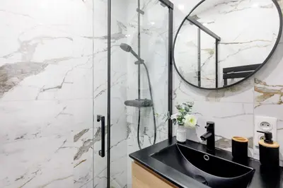 a bathroom with a black sink and a mirror at Carlton area lux 2 beds 2 baths in Cannes