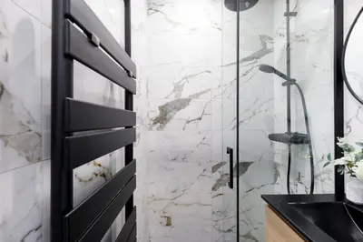 a bathroom with a shower and a black door at Carlton area lux 2 beds 2 baths in Cannes