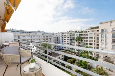 a balcony with chairs and a view of buildings at Carlton area lux 2 beds 2 baths in Cannes