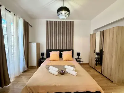 a bedroom with a large bed with two pillows at A006 Superbe Appartement dans le Carre d'Or-Cannes in Cannes
