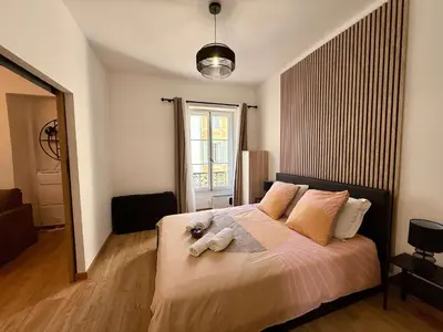 a bedroom with a bed with two stuffed animals on it at A006 Superbe Appartement dans le Carre d'Or-Cannes in Cannes