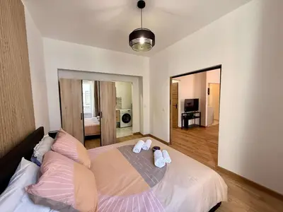 a bedroom with a large bed with towels on it at A006 Superbe Appartement dans le Carre d'Or-Cannes in Cannes