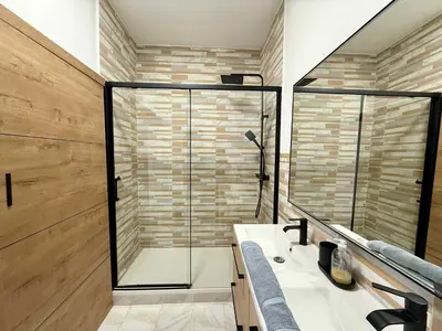 a bathroom with a glass shower and a sink at A006 Superbe Appartement dans le Carre d'Or-Cannes in Cannes