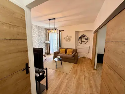 a living room with a couch and a table at A006 Superbe Appartement dans le Carre d'Or-Cannes in Cannes
