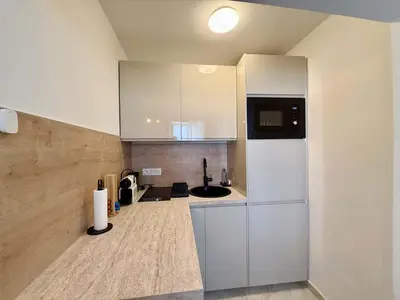a kitchen with a white refrigerator and a sink at A006 Superbe Appartement dans le Carre d'Or-Cannes in Cannes