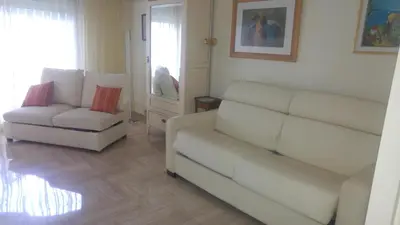 a living room with a couch and a chair at Gautier Jean in Cannes