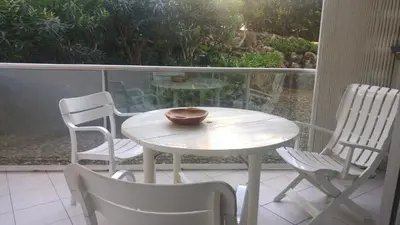 a white table and chairs on a balcony with a bowl on it at Gautier Jean in Cannes
