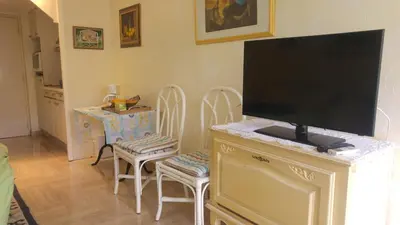 a living room with a flat screen tv on a dresser at Gautier Jean in Cannes