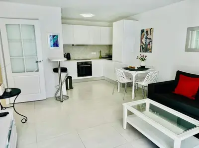 a living room with a couch and a table at Modern Bright Cannes Apt 2 min walk to the Beach in Cannes