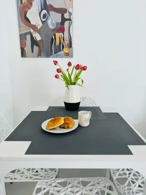 a table with a plate of bread and a cup of coffee at Modern Bright Cannes Apt 2 min walk to the Beach in Cannes