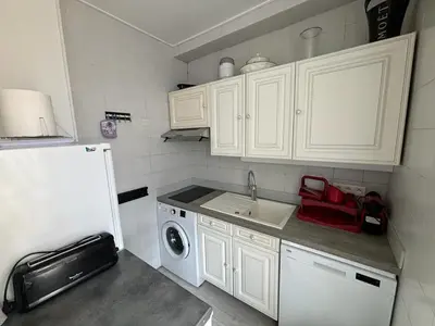 a small kitchen with a sink and a refrigerator at Studio Cannes Carré d'Or in Cannes