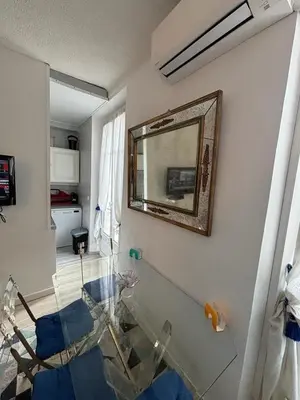a bathroom with a mirror and a glass table at Studio Cannes Carré d'Or in Cannes
