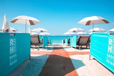 a row of chairs and umbrellas on a beach at Studio Cannes Carré d'Or in Cannes