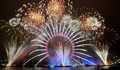 a fireworks display with a ferris wheel in the background at Studio Cannes Carré d'Or in Cannes