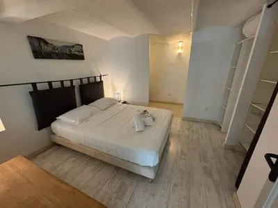 a bedroom with a bed with a teddy bear on it at Le Grenade - Spacieux 2 chambres Cannes centre 5min à pied in Cannes