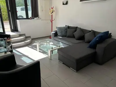 a living room with a couch and a glass table at Le Grenade - Spacieux 2 chambres Cannes centre 5min à pied in Cannes