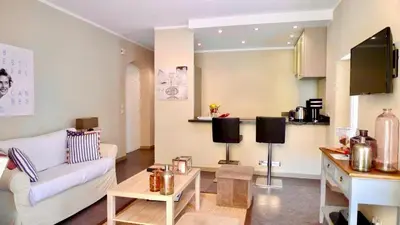 a living room with a couch and a table at Maison CENTRE CANNES 2 CHAMBRES 4 COUCHAGES in Cannes