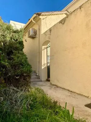 an entrance to a building with a door and grass at Maison CENTRE CANNES 2 CHAMBRES 4 COUCHAGES in Cannes