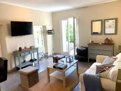 a living room with a couch and a table at Maison CENTRE CANNES 2 CHAMBRES 4 COUCHAGES in Cannes