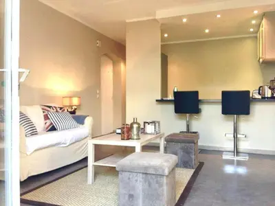 a living room with a couch and a table at Maison CENTRE CANNES 2 CHAMBRES 4 COUCHAGES in Cannes