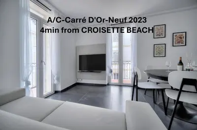a living room with a couch and a table at Design 2 pièces CARRE D'OR -COEUR DE CANNES A1B205 in Cannes