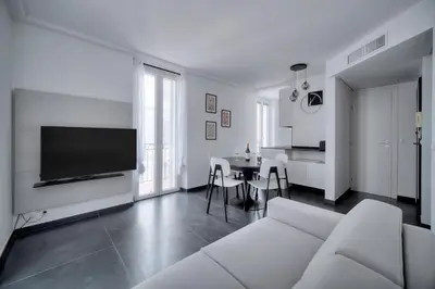 a living room with a white couch and a table at Design 2 pièces CARRE D'OR -COEUR DE CANNES A1B205 in Cannes