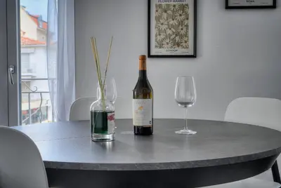 a bottle of wine and a glass on a table at Design 2 pièces CARRE D'OR -COEUR DE CANNES A1B205 in Cannes