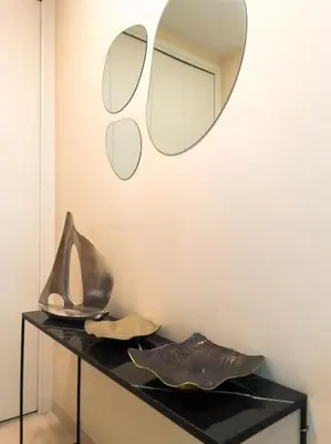 a black table with a mirror on a wall at Cocon paradisiaque avec piscine, terrasse, jardin au calme absolu in Cannes