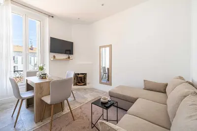 a living room with a couch and a table at Cozy One Bedroom apartment - heart of Cannes in Cannes