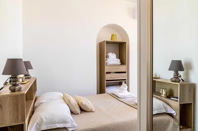 a bedroom with a bed and a mirror at Cozy One Bedroom apartment - heart of Cannes in Cannes
