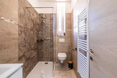 a bathroom with a shower and a toilet and a sink at Cozy One Bedroom apartment - heart of Cannes in Cannes