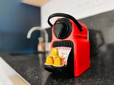 a red toaster sitting on top of a counter at Le TerrAzur - Logement 4 personnes Cannes in Cannes