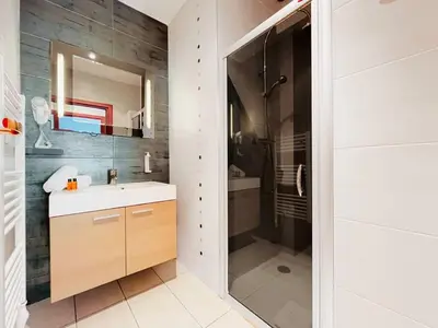 a bathroom with a shower and a sink and a mirror at Le TerrAzur - Logement 4 personnes Cannes in Cannes