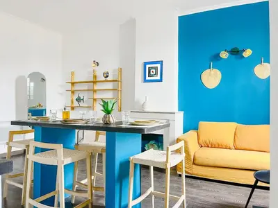 a living room with a table and a couch at Le BlueAzur - Proche Palais centre Cannes in Cannes