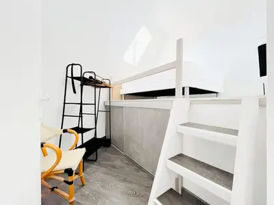 a room with a white bunk bed and a chair at Le BlueAzur - Proche Palais centre Cannes in Cannes