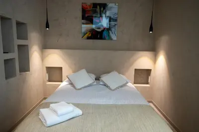 a bedroom with a white bed with two pillows at Modern 1-bedroom apartment with sea view on La Croisette in Cannes