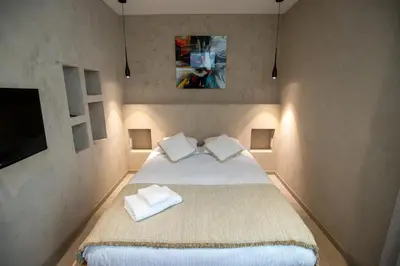 a bedroom with a large bed with two pillows at Modern 1-bedroom apartment with sea view on La Croisette in Cannes