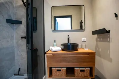 a bathroom with a sink and a mirror at Modern 1-bedroom apartment with sea view on La Croisette in Cannes